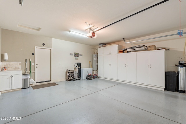 garage featuring a garage door opener and water heater