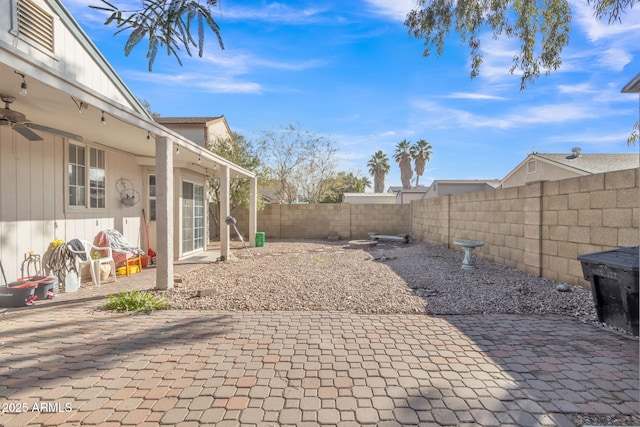 view of yard featuring a patio and ceiling fan