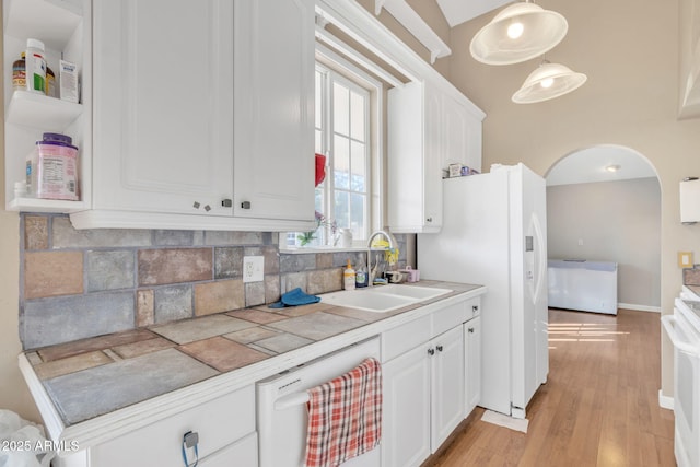 kitchen featuring sink, white appliances, tile counters, white cabinets, and decorative backsplash