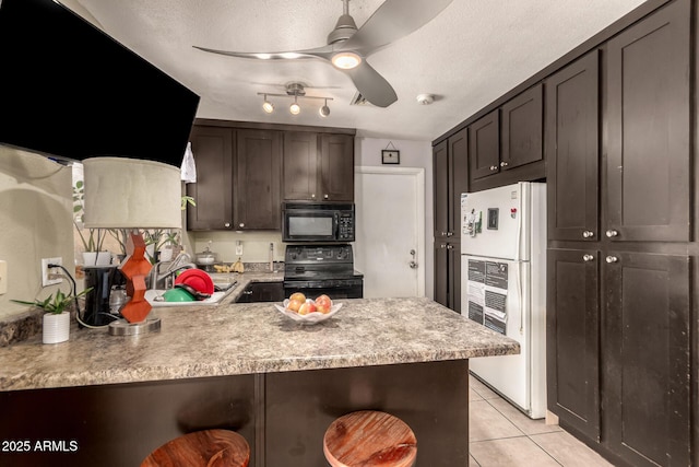 kitchen with ceiling fan, dark brown cabinetry, black appliances, and kitchen peninsula