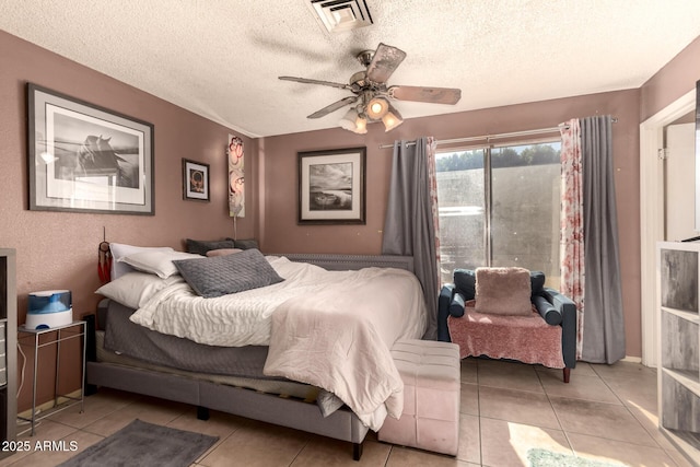 bedroom with ceiling fan, a textured ceiling, and light tile patterned floors