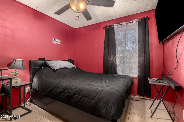 tiled bedroom featuring ceiling fan and a textured ceiling