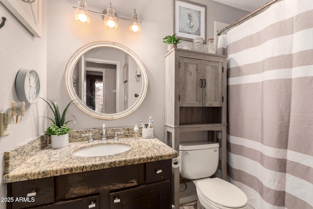 bathroom featuring toilet and vanity