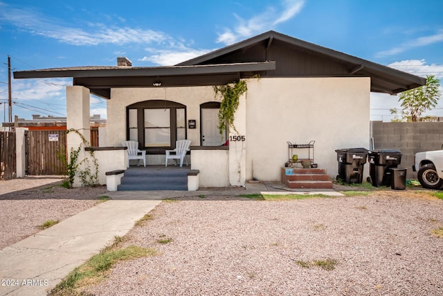 1505 W Fillmore St, Phoenix, AZ 85007 - view of front facade featuring a chimney, covered porch, stucco siding, and fence