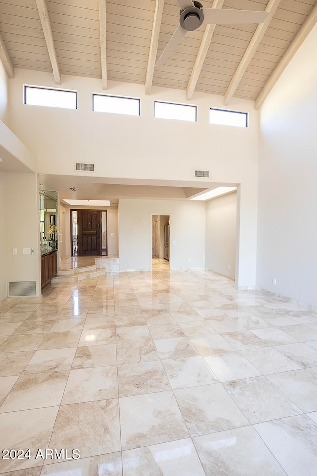 unfurnished room featuring beamed ceiling, high vaulted ceiling, and wood ceiling