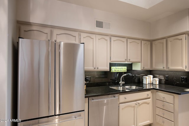 kitchen featuring decorative backsplash, sink, and stainless steel appliances