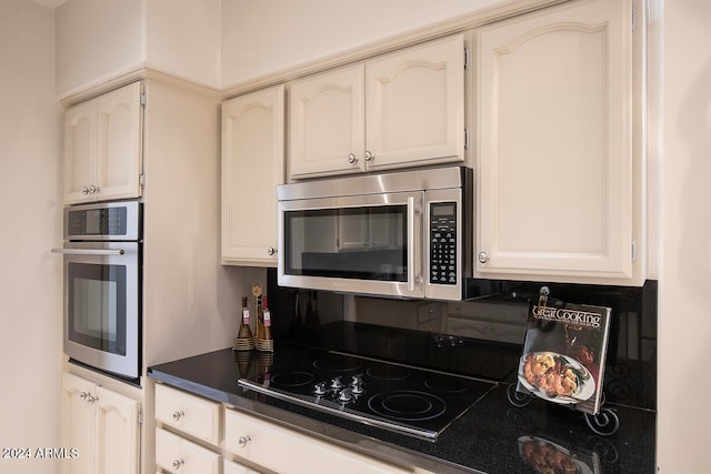 kitchen featuring white cabinets and appliances with stainless steel finishes