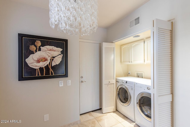 washroom featuring cabinets, light tile patterned floors, a chandelier, and independent washer and dryer