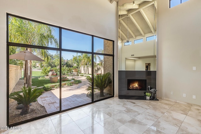 entryway featuring beamed ceiling and high vaulted ceiling