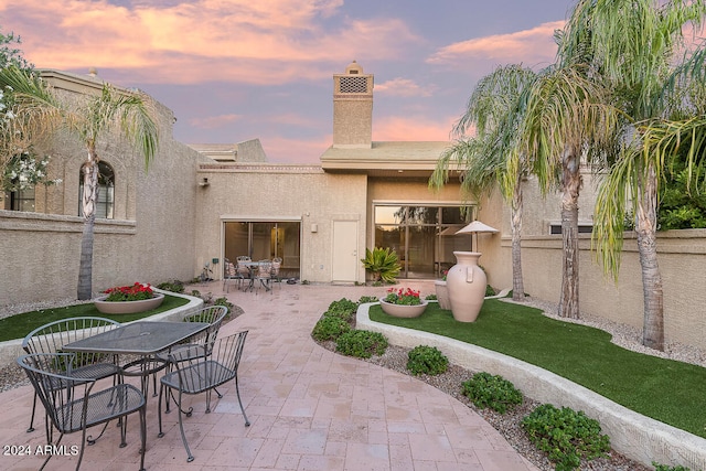 view of patio terrace at dusk