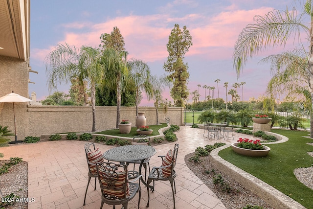 view of patio terrace at dusk