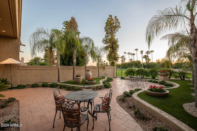 view of patio terrace at dusk