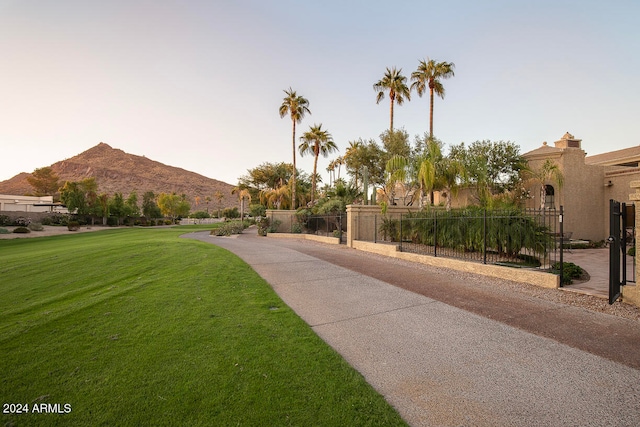 surrounding community featuring a lawn and a mountain view