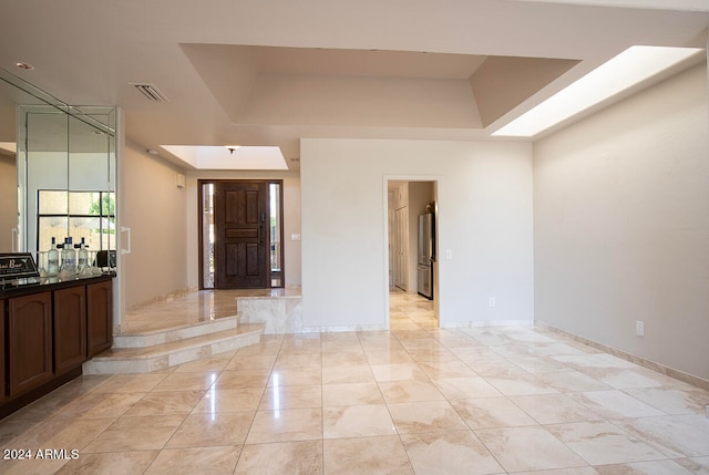 foyer entrance featuring a raised ceiling