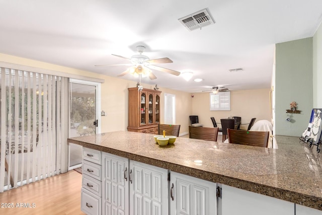 4046 E Crocus Dr, Phoenix, AZ 85032 - kitchen featuring a ceiling fan, white cabinetry, tile counters, and a peninsula