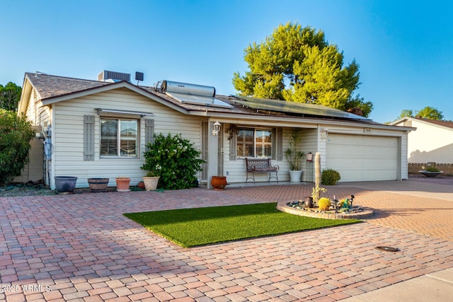 4046 E Crocus Dr, Phoenix, AZ 85032 - ranch-style house with a porch, decorative driveway, roof mounted solar panels, and an attached garage
