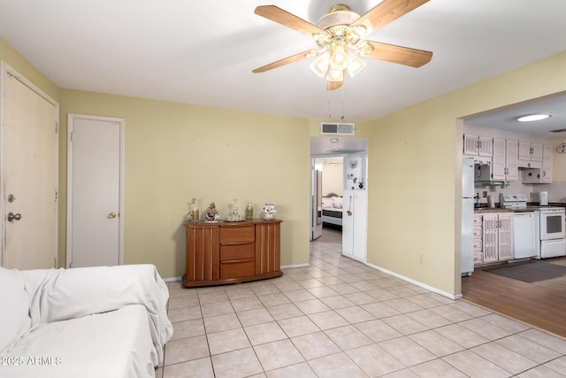 4046 E Crocus Dr, Phoenix, AZ 85032 - living area with light tile patterned floors and a ceiling fan