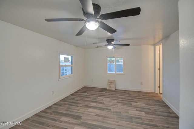 11014 W Cocopah St, Avondale, AZ 85323 - empty room featuring plenty of natural light, wood finished floors, and a ceiling fan