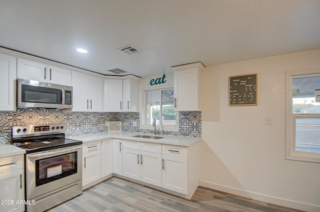 11014 W Cocopah St, Avondale, AZ 85323 - kitchen featuring appliances with stainless steel finishes, light wood-type flooring, tasteful backsplash, light countertops, and recessed lighting