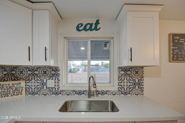 11014 W Cocopah St, Avondale, AZ 85323 - kitchen with white cabinetry, decorative backsplash, and light stone countertops