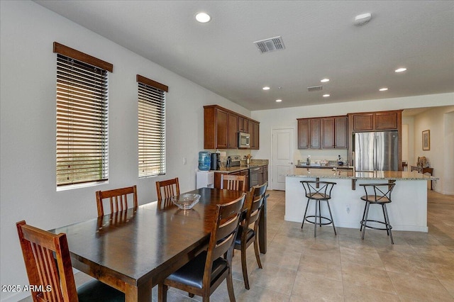 dining area with light tile patterned floors