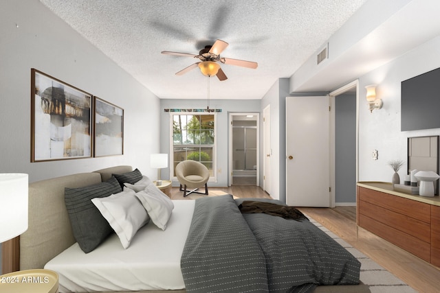 bedroom with ceiling fan, light hardwood / wood-style flooring, and a textured ceiling