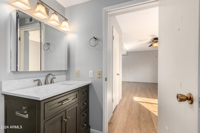 bathroom with vanity, hardwood / wood-style flooring, and ceiling fan