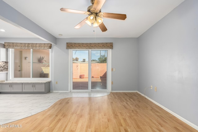 interior space with ceiling fan and light hardwood / wood-style flooring