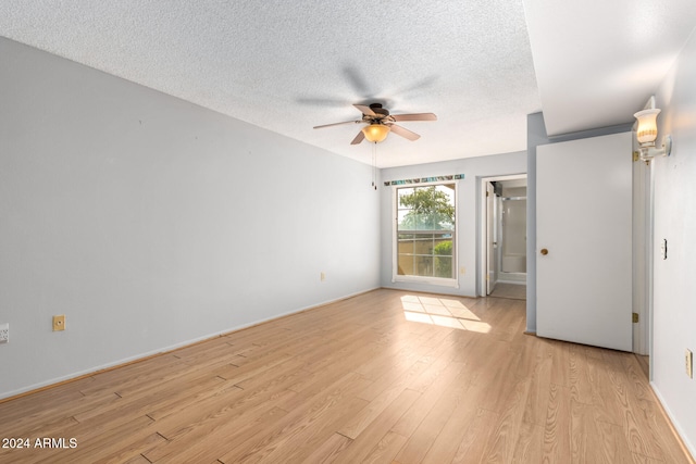 unfurnished room with ceiling fan, light hardwood / wood-style floors, and a textured ceiling