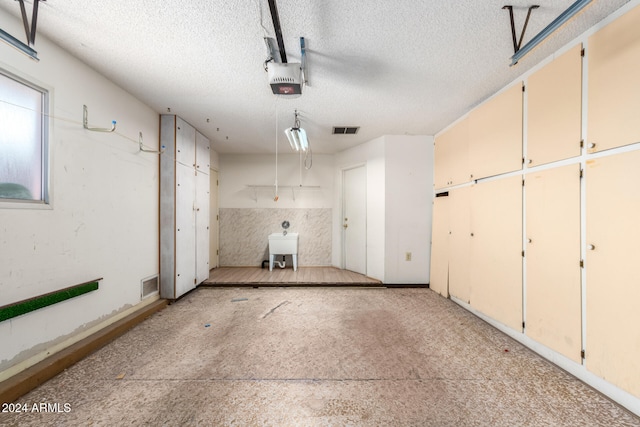 garage with sink and a garage door opener