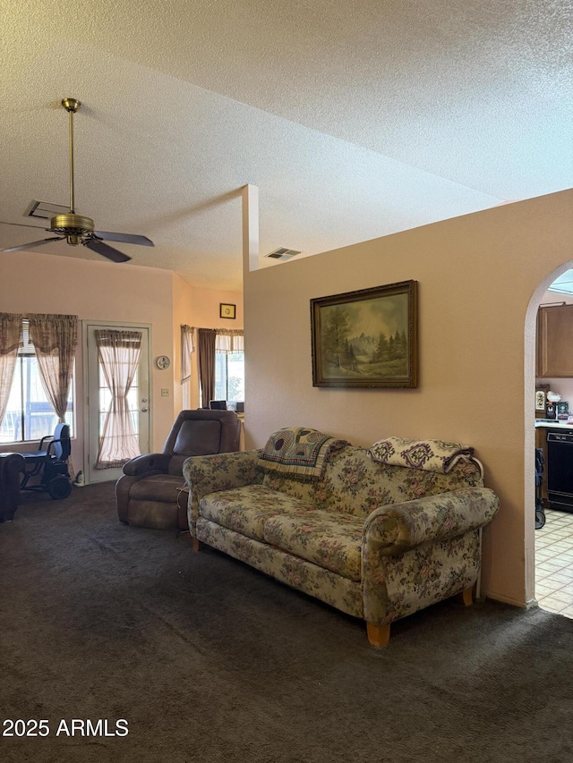 5430 N 74th Ave, Glendale, AZ 85303 - carpeted living room featuring arched walkways, plenty of natural light, a ceiling fan, and visible vents