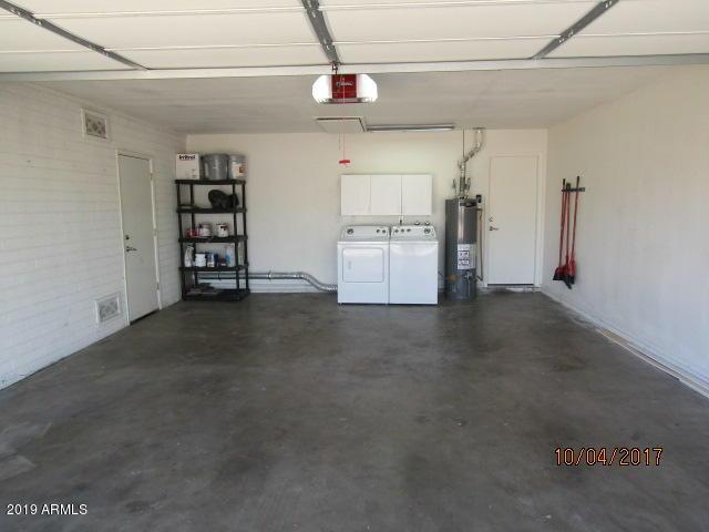 327 E Ln Jolla Dr, Tempe, AZ 85282 - garage featuring water heater, a garage door opener, and washing machine and dryer