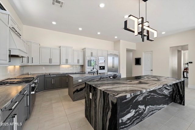 29215 N 136th St, Scottsdale, AZ 85262 - kitchen featuring a large island with sink, high end appliances, a sink, light tile patterned floors, and recessed lighting