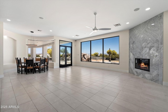29215 N 136th St, Scottsdale, AZ 85262 - living room with light tile patterned floors, a fireplace, baseboards, recessed lighting, and a ceiling fan