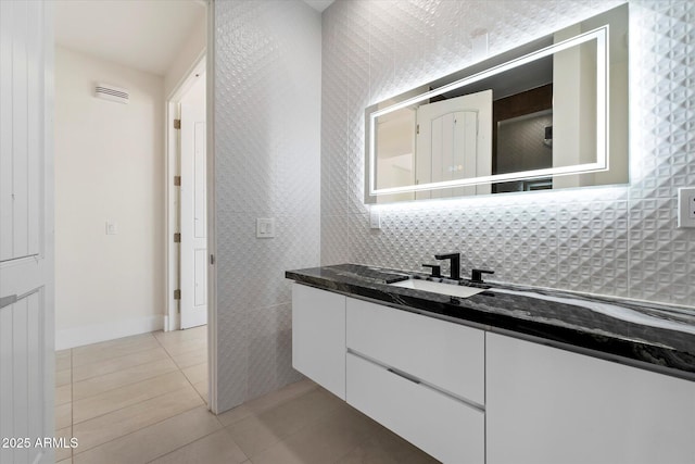 29215 N 136th St, Scottsdale, AZ 85262 - bathroom featuring vanity, tile patterned floors, baseboards, and tasteful backsplash