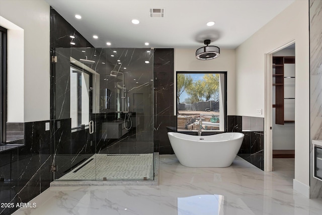29215 N 136th St, Scottsdale, AZ 85262 - bathroom featuring a soaking tub, marble tiled floors, tile walls, a marble finish shower, and recessed lighting
