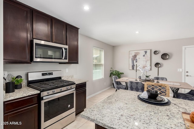 8208 W Albeniz Pl, Phoenix, AZ 85043 - kitchen with appliances with stainless steel finishes, light tile patterned flooring, dark brown cabinets, recessed lighting, and baseboards