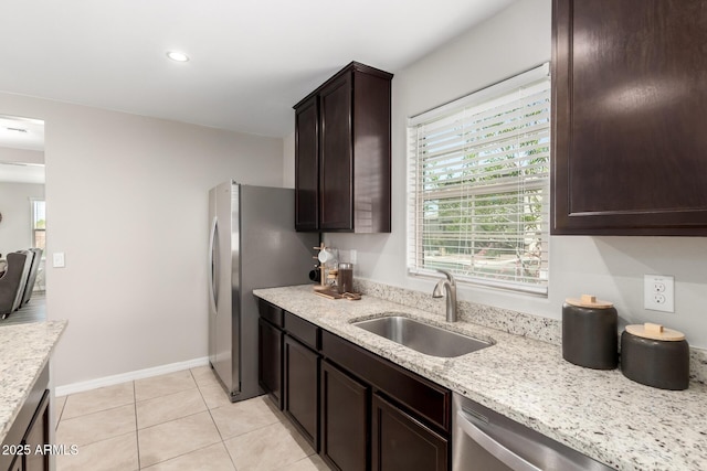 8208 W Albeniz Pl, Phoenix, AZ 85043 - kitchen featuring a sink, dark brown cabinetry, plenty of natural light, light stone counters, and recessed lighting