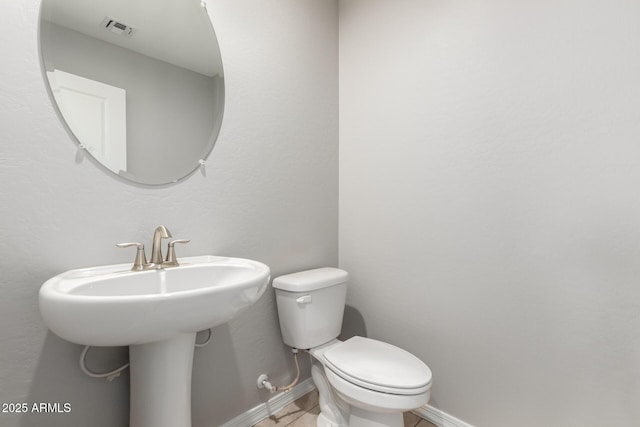 8208 W Albeniz Pl, Phoenix, AZ 85043 - half bathroom featuring baseboards, toilet, a sink, and tile patterned floors