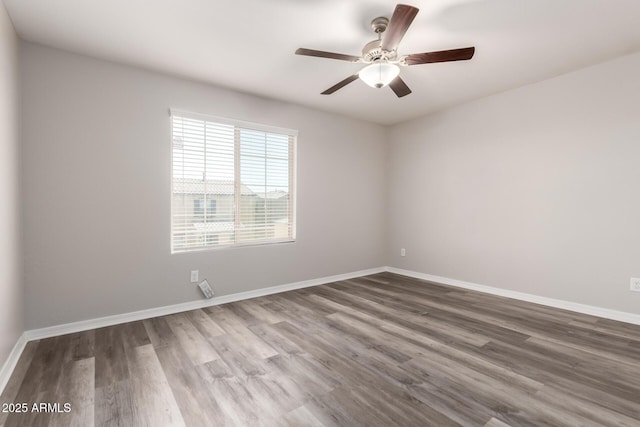 8208 W Albeniz Pl, Phoenix, AZ 85043 - empty room with wood finished floors, ceiling fan, and baseboards