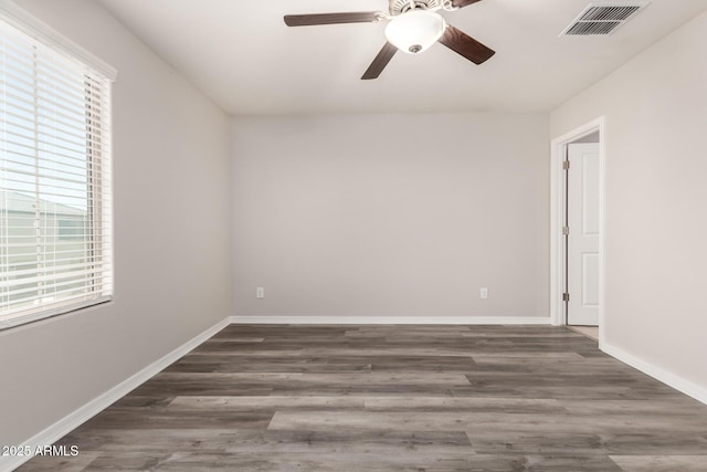 8208 W Albeniz Pl, Phoenix, AZ 85043 - unfurnished room featuring healthy amount of natural light, wood finished floors, and ceiling fan
