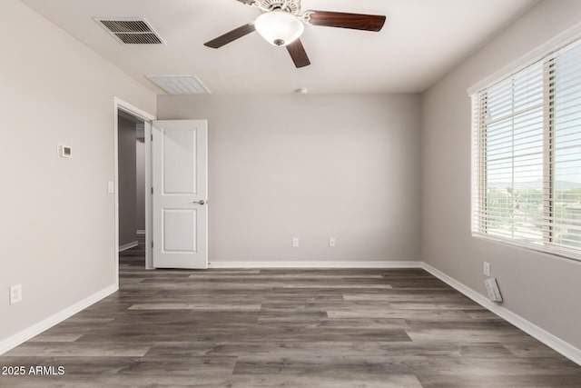 8208 W Albeniz Pl, Phoenix, AZ 85043 - spare room with healthy amount of natural light, ceiling fan, wood finished floors, and baseboards
