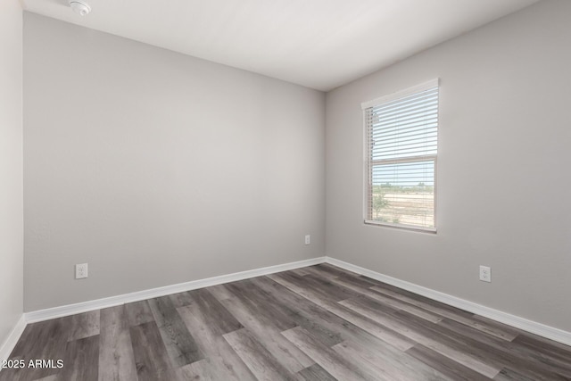 8208 W Albeniz Pl, Phoenix, AZ 85043 - empty room with dark wood-type flooring, baseboards, and a smoke detector