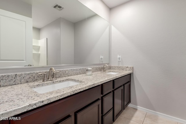 8208 W Albeniz Pl, Phoenix, AZ 85043 - full bath with tile patterned floors, baseboards, and double vanity