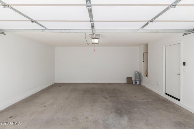 8208 W Albeniz Pl, Phoenix, AZ 85043 - garage featuring a garage door opener and baseboards