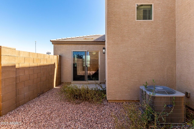 8208 W Albeniz Pl, Phoenix, AZ 85043 - entrance to property with fence, cooling unit, and stucco siding