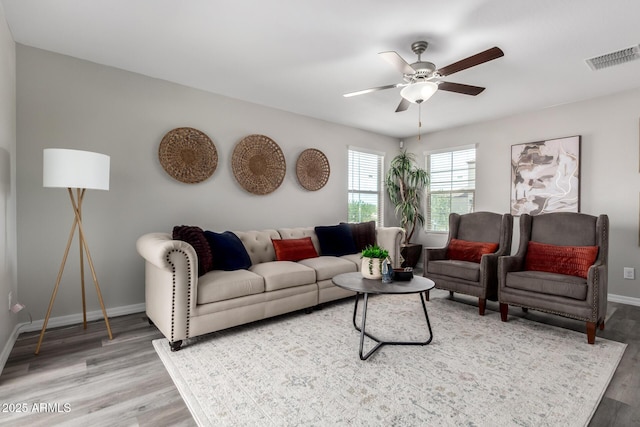8208 W Albeniz Pl, Phoenix, AZ 85043 - living room featuring a ceiling fan, wood finished floors, and baseboards