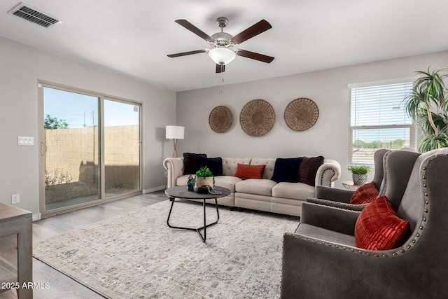 8208 W Albeniz Pl, Phoenix, AZ 85043 - living area with plenty of natural light, ceiling fan, wood finished floors, and baseboards