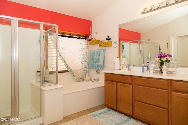 bathroom with vanity, vaulted ceiling, tile patterned flooring, and plus walk in shower