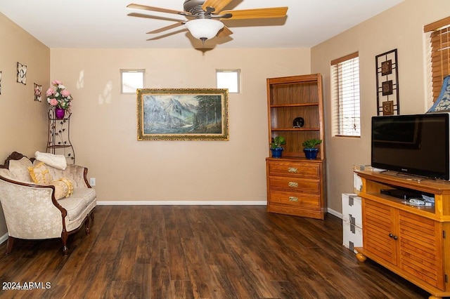 living area with ceiling fan and dark hardwood / wood-style floors